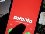 The logo of Indian food delivery company Zomato is seen on its app on a mobile phone displayed in front of its company website in this illustration picture taken July 14, 2021.(Florence Lo/Reuters)