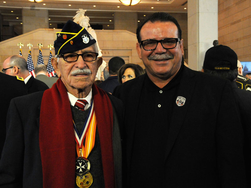 Private First Class Miguel Rodriguez Colon standing with his son