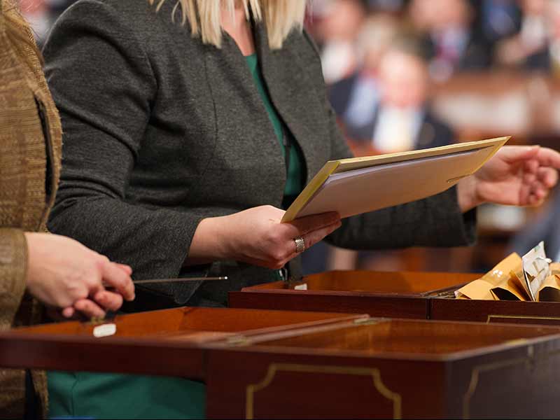 Two people standing in front of two wooden chests