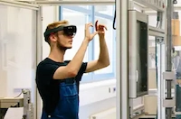 A man wearing a VR headset, experiencing the high-speed of 5G connections in Singapore