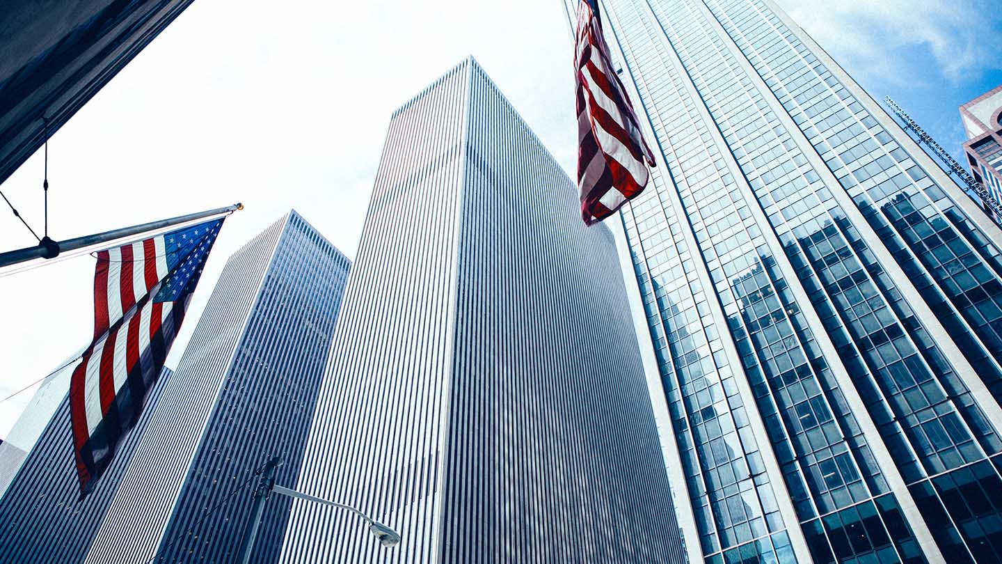 USA flag on glass skyscrapers in New York