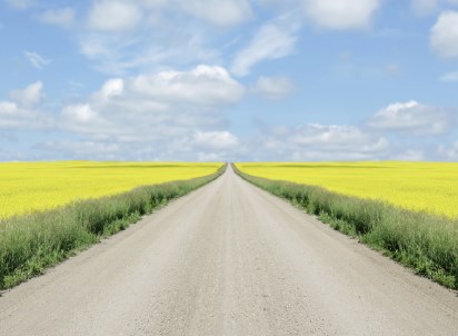 Open gravel road with blue sky