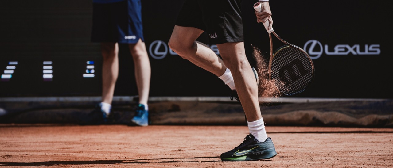 Two people standing on a tennis court