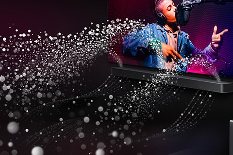 LG TV and LG Soundbar are in a black room playing a musical performance. White droplets representing soundwaves shoot upwards and forward from the soundbar.