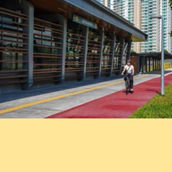 Image of exterior of TEL4 Marine Terrace station with green bus passing by