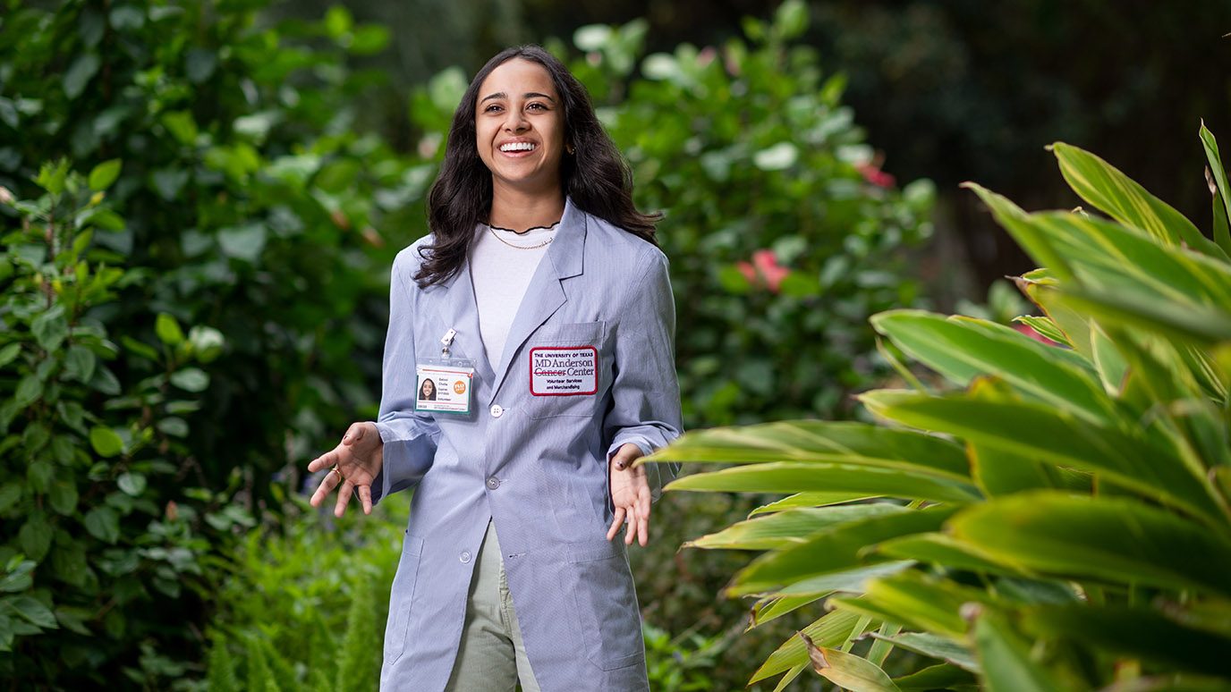 Volunteer Saloni Cholia wears her blue jacket in the garden at MD Anderson