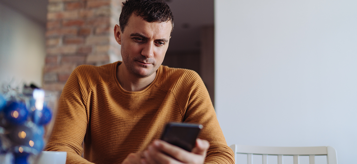 Photo of a person using a mobile device at home