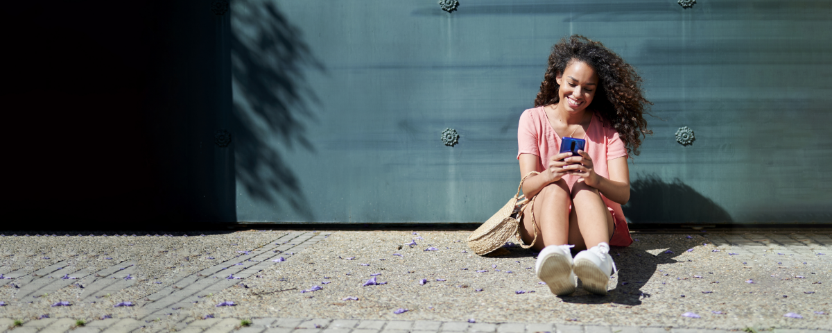 Women sat looking at her mobile 