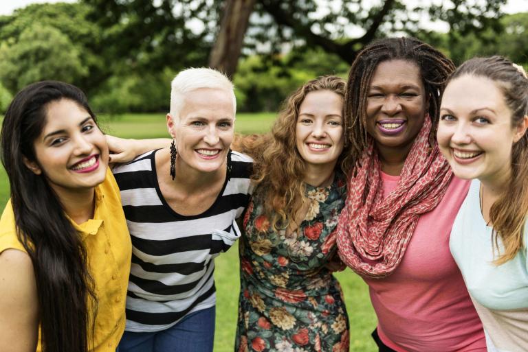 A group of multigenerational women smiling.