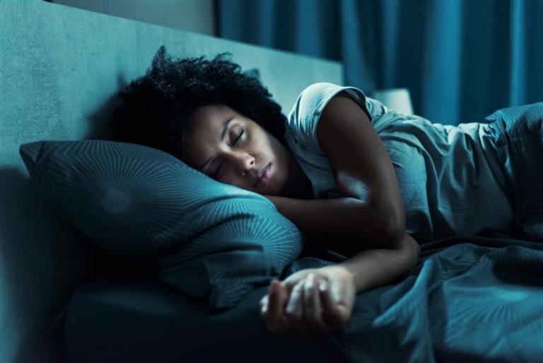 Woman sleeping on a bed.