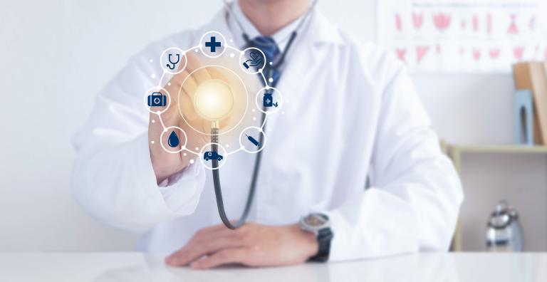 A doctor holding up a glowing stethoscope with blue icons circling around it. Starting at the top going clockwise the icons are a medical cross, a palm holding a heart, a bottle of medicine, a syringe, an ambulance, a drop of blood, a medical bag, and a stethescope. 