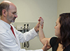 Photo of doctor examing young woman's elbow