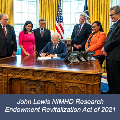 NIMHD Director Dr. Pérez-Stable, NIH Acting Director Dr. Tabak, HHS Secretary Becerra, Congressional leaders with President Biden signing the John Lewis NIMHD Research Endowment Revitalization Act of 2021