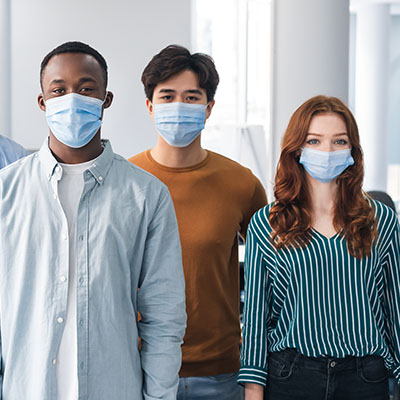 Three masked people of different races, ethnicities and genders