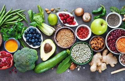 an assortment of fresh fruits and vegetables laid out on a countertop