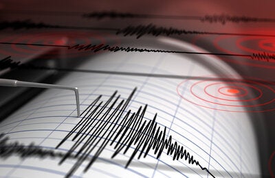 Seismograph with paper in action and earthquake