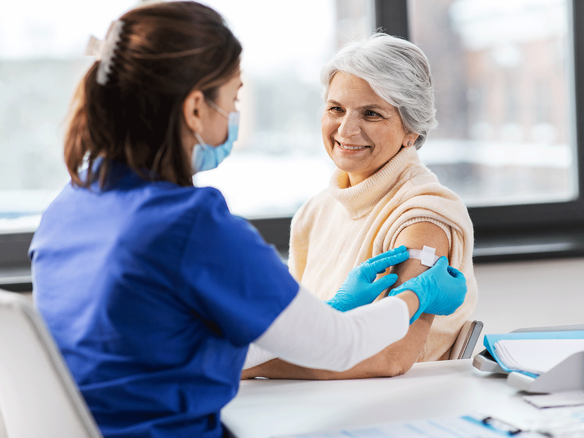 Medical worker applying an adhesive bandage on a patient