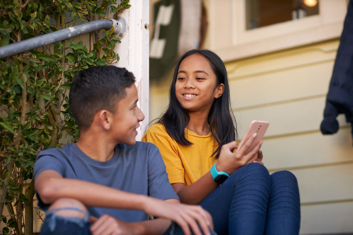 Kids with mobile on porch