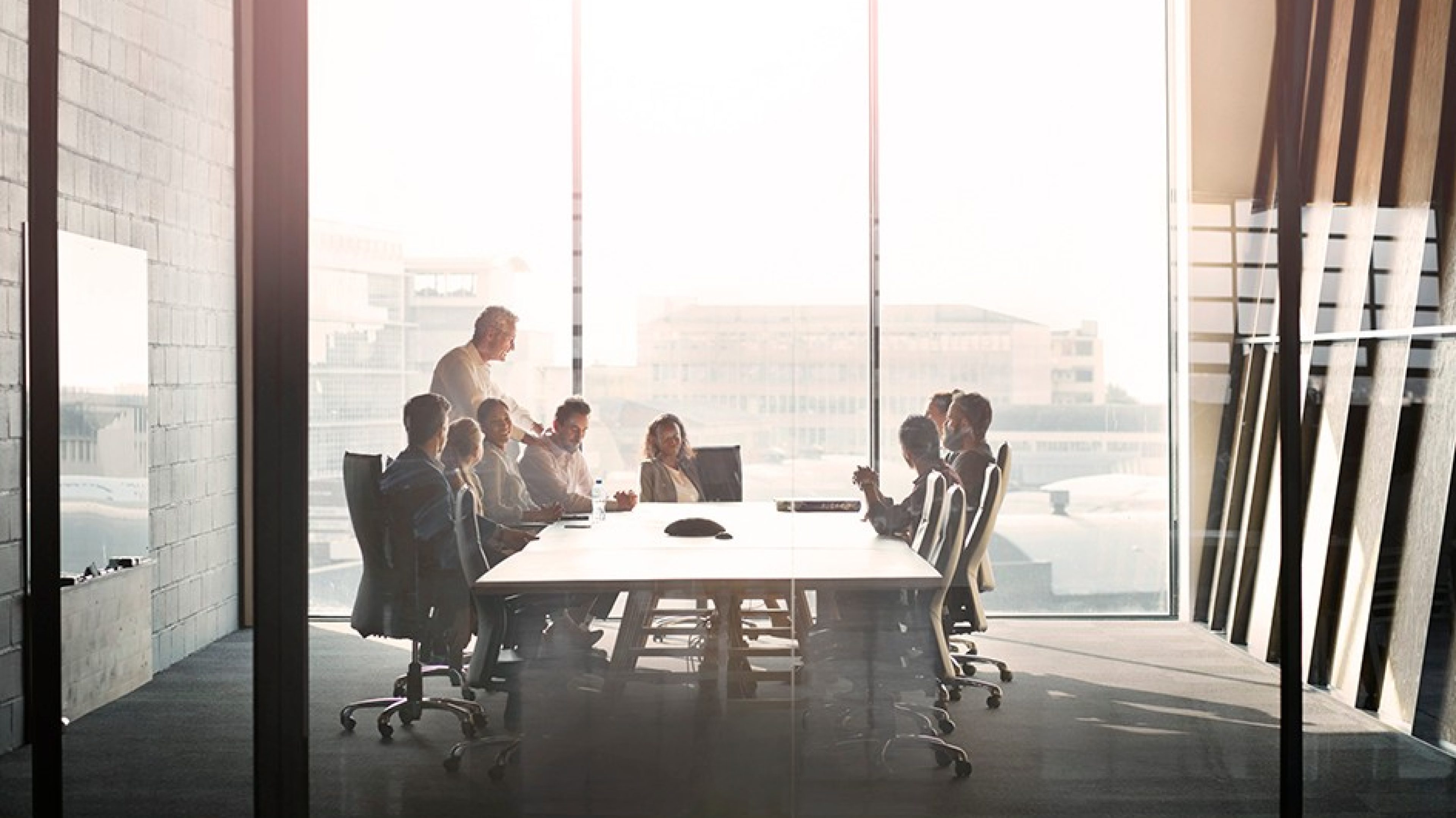 CEO giving peptalk to businesspeople at meeting in big conferenceroom