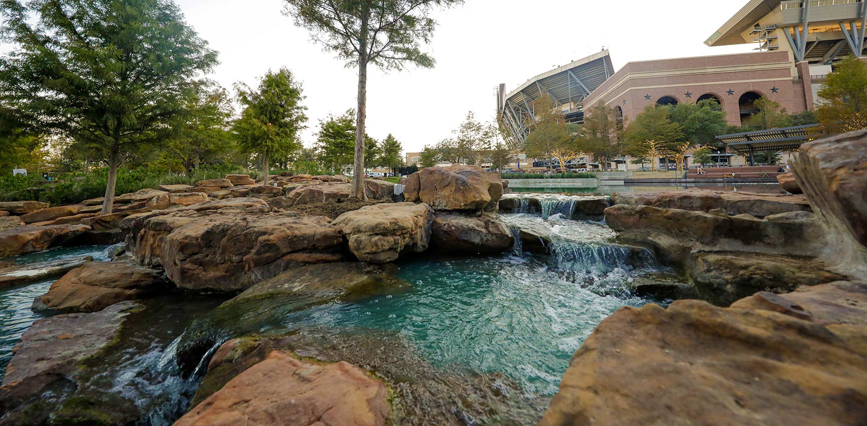 The pond at Aggie Park with Kyle Field in the background