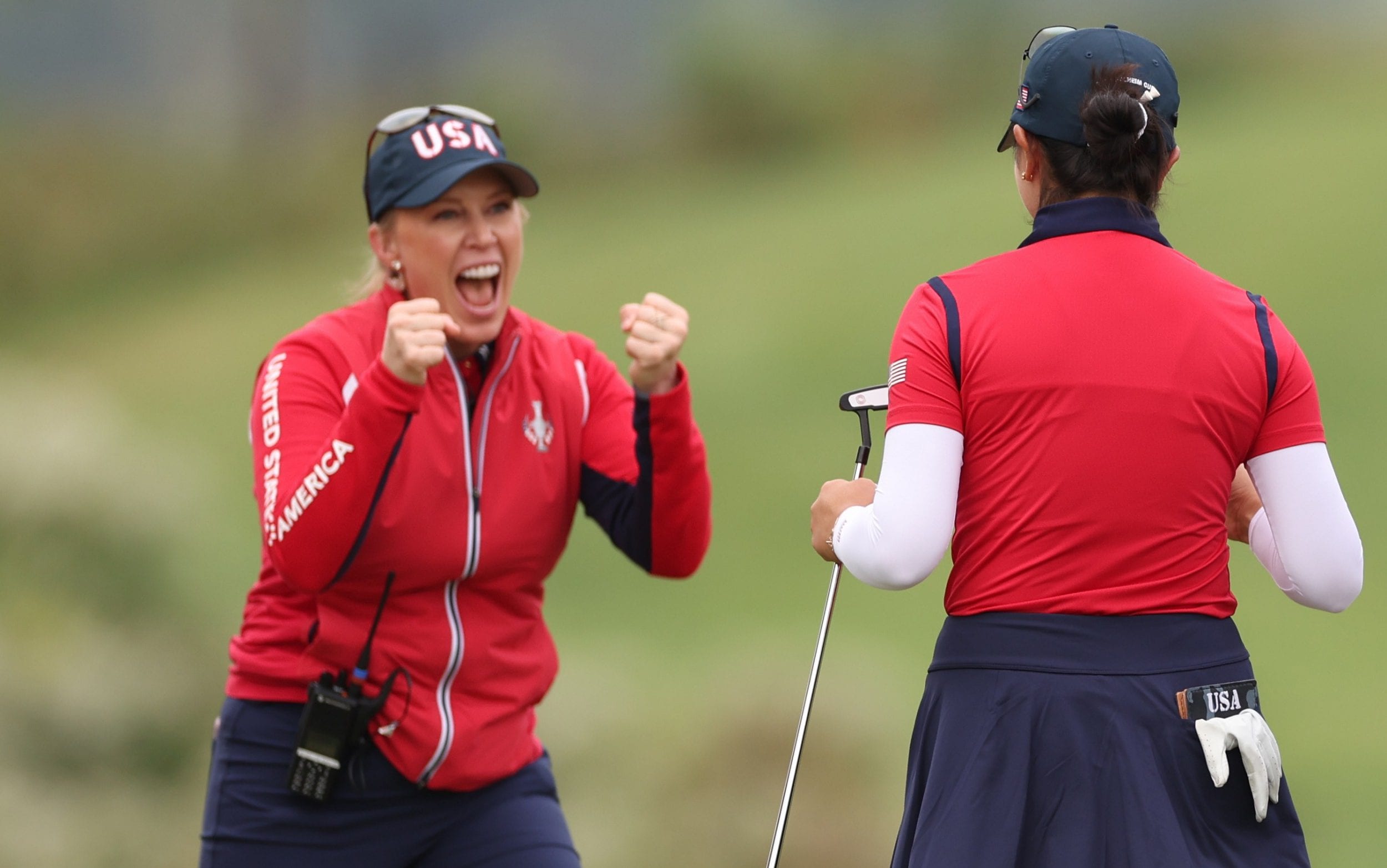 Assistant Captain Morgan Pressel reacts with Rose Zhang of Team United States after her winning putt on the 16th green during the Friday Foursomes matches against Team Europe during the first round of the Solheim Cup 2024 at Robert Trent Jones Golf Club on September 13, 2024 in Gainesville, Virginia