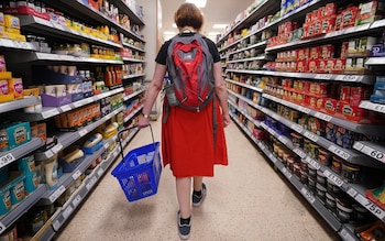 Shopper walking through the aisle of a supermarket