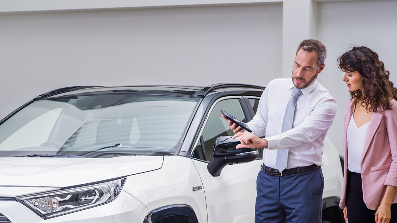 Toyota salesman helping interested customer