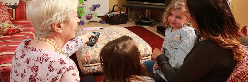 Family watching TV using electricity