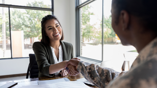 case manager shaking hands with AD soldier