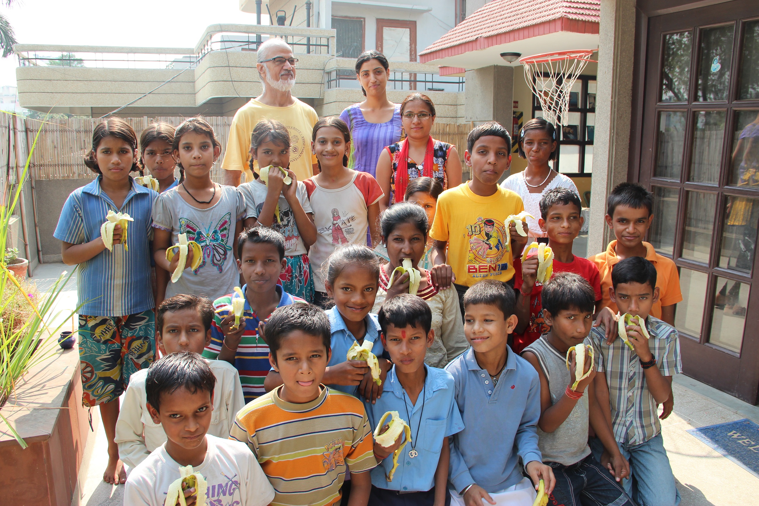 Group of children eating bananas