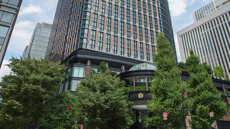 Photo of the Matsumoto glass tower block with trees in the foreground