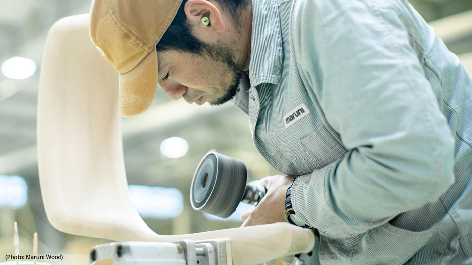 Photo of a Maruni Wood woodworker fine-carving wooden chairs