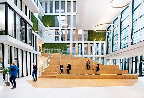  People sit and walk in an atrium