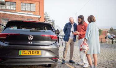 EV charging - three people look at Zapmap app